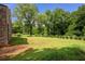 Expansive backyard with lush green grass, mature trees, and plenty of open space at 538 Main St, Palmetto, GA 30268