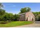 Brick building exterior with neatly landscaped yard, mature trees, and a gravel driveway at 538 Main St, Palmetto, GA 30268