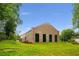 Brick building exterior with large windows, a well-maintained lawn, and lush greenery at 538 Main St, Palmetto, GA 30268