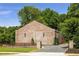 Unique brick building with professional landscaping and stylish stone and iron fence at 538 Main St, Palmetto, GA 30268