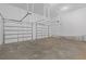 Spacious and uncluttered two-car garage with white doors and concrete floor at 538 Main St, Palmetto, GA 30268