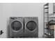 Convenient laundry room with a modern washer and dryer set and storage shelves at 538 Main St, Palmetto, GA 30268