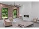 Bright living room features a sleek fireplace, modern furniture, and tree views at 538 Main St, Palmetto, GA 30268