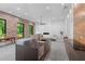 Open concept living area showcasing exposed brick, modern kitchen with sleek island and stainless steel appliances at 538 Main St, Palmetto, GA 30268
