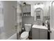 Cozy bathroom with a vanity, tub/shower combo, and built-in shelving at 107 Barrington Hills Dr, Atlanta, GA 30350