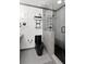 Contemporary bathroom boasts a walk-in shower, modern black toilet, gray tiled floors, and minimalist decor at 107 Barrington Hills Dr, Atlanta, GA 30350