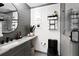 Modern bathroom featuring gray plank accent wall, stone counter, and a sleek black toilet and glass-enclosed shower at 107 Barrington Hills Dr, Atlanta, GA 30350