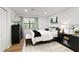 Well-lit bedroom featuring a daybed, dark dresser and streamlined grey and white decor with bright light from the window at 107 Barrington Hills Dr, Atlanta, GA 30350