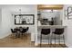 Modern dining room with stylish lighting fixture and view into kitchen area at 107 Barrington Hills Dr, Atlanta, GA 30350