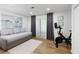 Multi-purpose room with workout bike and grey daybed with access to outdoor balcony area at 107 Barrington Hills Dr, Atlanta, GA 30350