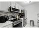 Updated kitchen featuring stainless appliances, light cabinetry, and stylish backsplash at 107 Barrington Hills Dr, Atlanta, GA 30350