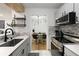 Open kitchen and dining area with stainless steel appliances and modern finishes at 107 Barrington Hills Dr, Atlanta, GA 30350
