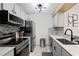 Modern kitchen with stainless steel appliances, white cabinets, and stylish backsplash at 107 Barrington Hills Dr, Atlanta, GA 30350