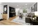 Modern living room with a fireplace, neutral-toned furniture, and natural light at 107 Barrington Hills Dr, Atlanta, GA 30350