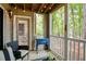 Serene patio with comfortable seating and beverage cooler overlooking lush greenery, perfect for outdoor relaxation at 107 Barrington Hills Dr, Atlanta, GA 30350