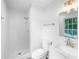 Bright bathroom featuring a shower with white tile and modern fixtures at 191 High Creek Dr, Roswell, GA 30076