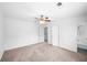 Spacious bedroom with neutral carpet, ceiling fan, and ensuite bathroom access at 191 High Creek Dr, Roswell, GA 30076