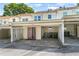 Charming townhouse featuring a carport and a welcoming red-framed glass door entrance at 191 High Creek Dr, Roswell, GA 30076