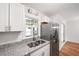 Kitchen with stainless steel refrigerator, granite countertops, double sink and window at 191 High Creek Dr, Roswell, GA 30076