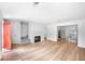 Open-concept living room with fireplace and modern flooring, flooded with natural light at 191 High Creek Dr, Roswell, GA 30076