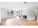 Bright living room with fireplace, large windows, and modern flooring, perfect for relaxation at 191 High Creek Dr, Roswell, GA 30076