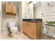 Bright bathroom features a toilet, sink, vanity with granite countertops, and neutral-toned tile flooring at 195 14Th Ne St # 1501, Atlanta, GA 30309