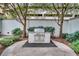 Outdoor grill area with stainless steel grill, surrounded by lush landscaping and hardscape at 195 14Th Ne St # 1501, Atlanta, GA 30309