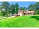 Traditional two-story brick home with a large front lawn and mature trees at 2117 Chestnut Hill Circle Cir, Decatur, GA 30032