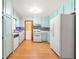 Retro kitchen with wood floors and blue cabinets featuring a white refrigerator and stove at 2117 Chestnut Hill Circle Cir, Decatur, GA 30032