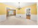 Bright living room with yellow walls, white trim, and a chandelier at 2117 Chestnut Hill Circle Cir, Decatur, GA 30032