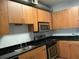 Updated kitchen features stainless steel appliances, wood cabinets, granite countertops and gas range at 238 Walker Sw St # 22, Atlanta, GA 30313