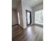 Living room features light colored walls, modern blinds, access to exterior balcony, and wood floors at 238 Walker Sw St # 22, Atlanta, GA 30313