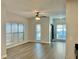 Bright living room featuring wood floors, ceiling fan, and large windows with outside views at 238 Walker Sw St # 22, Atlanta, GA 30313