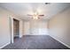 The bedroom has gray carpet, a ceiling fan, two doors, and a closet with bifold doors at 446 Jaywood Dr, Stone Mountain, GA 30083