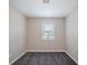A gray carpeted bedroom features neutral walls and a window at 446 Jaywood Dr, Stone Mountain, GA 30083