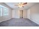 The bedroom has gray carpet, a ceiling fan, two doors, a window, and a walk-in closet at 446 Jaywood Dr, Stone Mountain, GA 30083