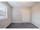 The gray carpeted bedroom features a closet and a window at 446 Jaywood Dr, Stone Mountain, GA 30083