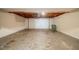 Unfinished garage with exposed ceiling and concrete floor at 446 Jaywood Dr, Stone Mountain, GA 30083