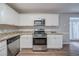 Well-equipped kitchen featuring modern appliances, stone countertops, and sleek cabinets for culinary endeavors at 446 Jaywood Dr, Stone Mountain, GA 30083