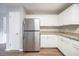 Functional kitchen with white cabinets, stone countertops, and stainless steel fridge for convenient meal prep at 446 Jaywood Dr, Stone Mountain, GA 30083