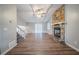 Bright living room with a stone fireplace, ceiling fan, wood floors, and stairs to the upper level at 446 Jaywood Dr, Stone Mountain, GA 30083