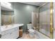 Bathroom showcasing a single sink vanity with a framed glass enclosed tub shower at 719 Mcgill Park Ne Ave, Atlanta, GA 30312