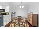 Cozy dining area with a round glass table, hardwood floors, and modern light fixture at 719 Mcgill Park Ne Ave, Atlanta, GA 30312