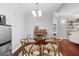 Stylish dining area with a round glass table, hardwood floors, and modern light fixture at 719 Mcgill Park Ne Ave, Atlanta, GA 30312