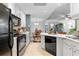 Bright open-concept kitchen with white cabinets and a view of the dining and living spaces at 719 Mcgill Park Ne Ave, Atlanta, GA 30312