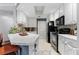 Bright kitchen featuring white cabinetry, marbled countertops, and black appliances for a modern, clean aesthetic at 719 Mcgill Park Ne Ave, Atlanta, GA 30312