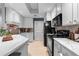 Clean kitchen with white cabinets, modern appliances, tile backsplash, and marble countertops at 719 Mcgill Park Ne Ave, Atlanta, GA 30312