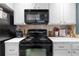 Close-up of a modern kitchen, showcasing a black stove, oven, and microwave at 719 Mcgill Park Ne Ave, Atlanta, GA 30312