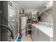 Functional laundry room with washer, dryer, storage shelves, and water heater at 719 Mcgill Park Ne Ave, Atlanta, GA 30312