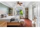 Bright main bedroom with hardwood floors, bay window, tray ceiling, and plants at 719 Mcgill Park Ne Ave, Atlanta, GA 30312